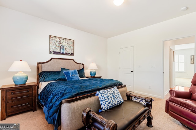 bedroom with light carpet and baseboards