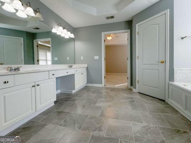 full bathroom with double vanity, visible vents, baseboards, and a garden tub