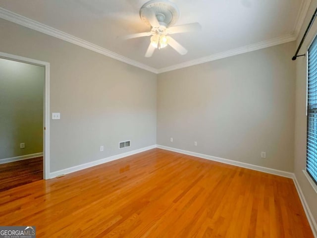 empty room with baseboards, light wood-type flooring, a ceiling fan, and ornamental molding