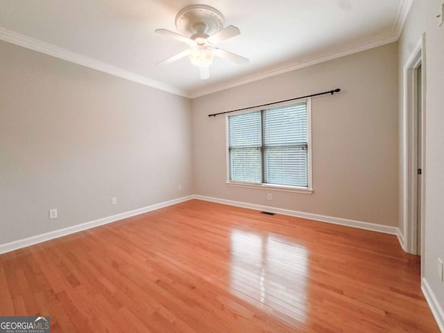 unfurnished bedroom with ceiling fan, light wood-style floors, baseboards, and ornamental molding