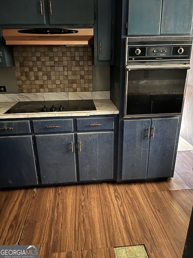 109 E Main St, Manchester, GA 31816 - kitchen with black appliances, wood finished floors, extractor fan, and light countertops