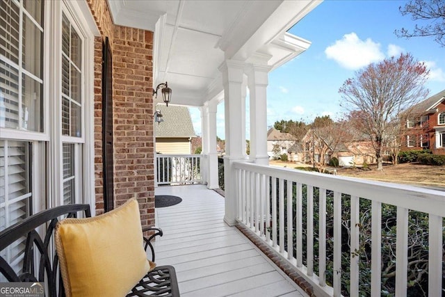 balcony with covered porch and a residential view