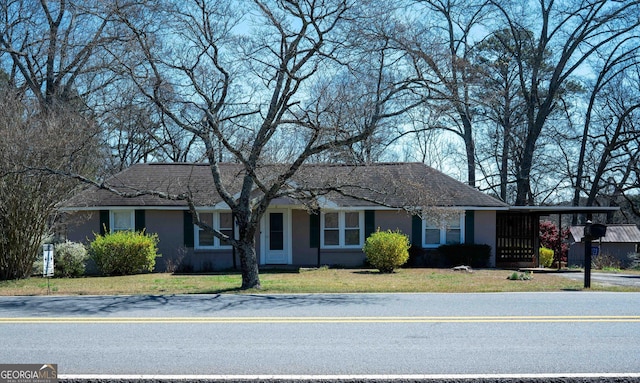 single story home with a front yard and stucco siding