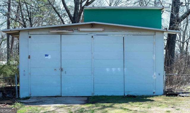 garage featuring a storage shed