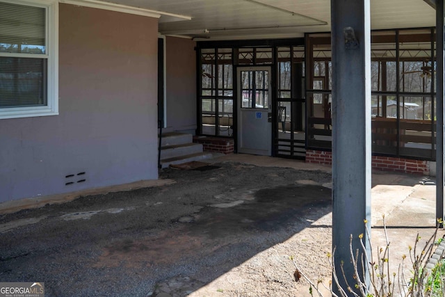 property entrance featuring stucco siding