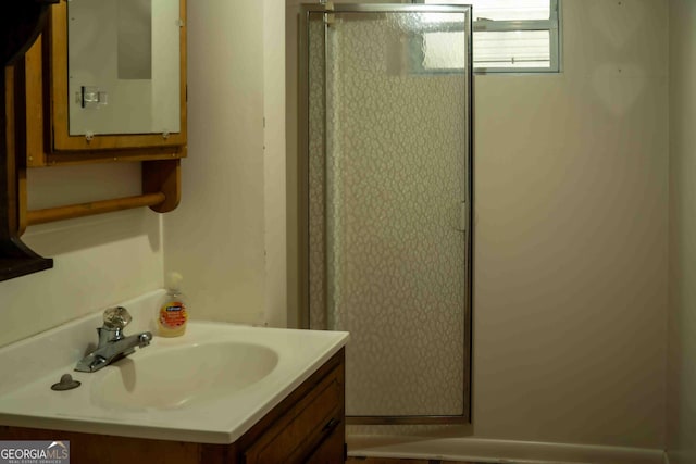 bathroom with vanity and a shower stall