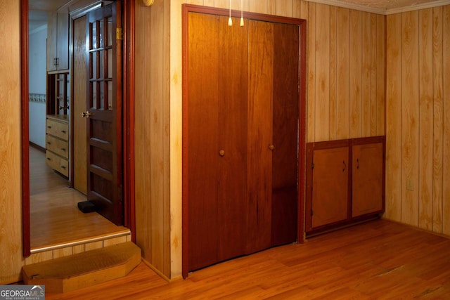 hall featuring wooden walls and light wood-style floors