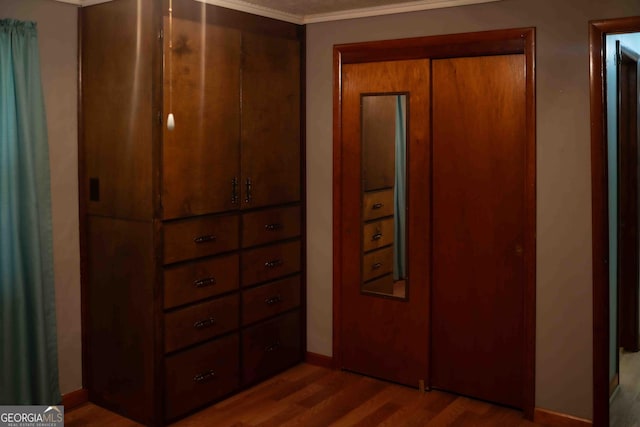 bedroom featuring baseboards and wood finished floors