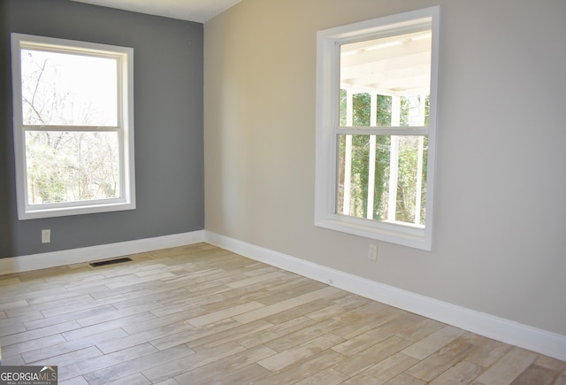 110 Wildwood Cir, Gainesville, GA 30501 - empty room featuring a wealth of natural light, visible vents, baseboards, and light wood-style floors