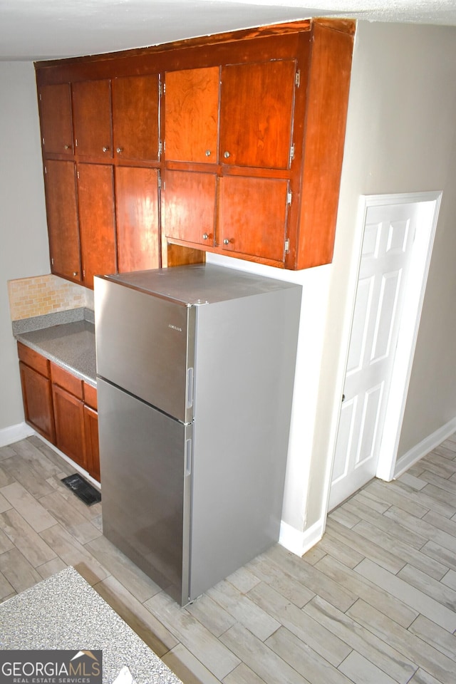 110 Wildwood Cir, Gainesville, GA 30501 - kitchen with light countertops, freestanding refrigerator, and wood tiled floor