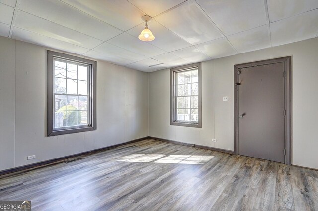 empty room with visible vents and wood finished floors