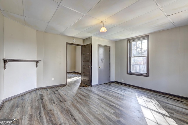 unfurnished bedroom featuring baseboards and wood finished floors