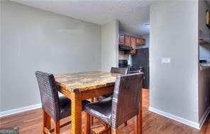 dining space featuring dark wood finished floors and baseboards