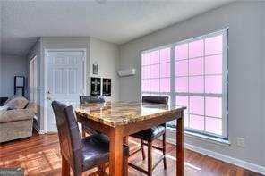 dining area featuring baseboards and dark wood-style flooring