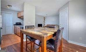 dining area featuring baseboards and wood finished floors