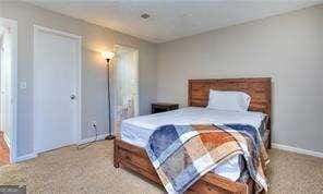 bedroom with carpet flooring and baseboards