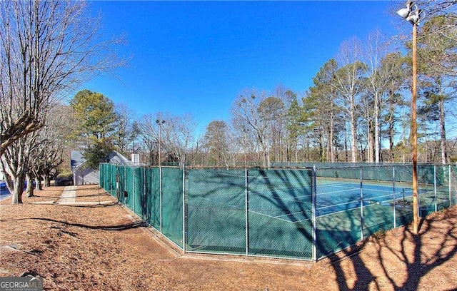 view of tennis court with fence