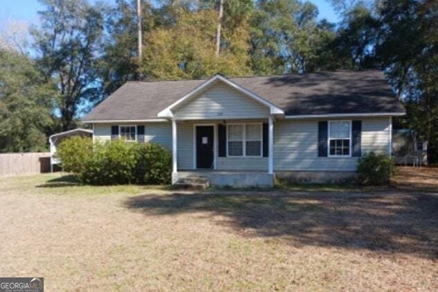 ranch-style house with a porch and a front yard