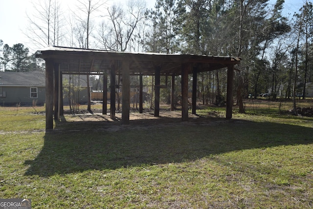 view of property's community featuring a lawn and fence