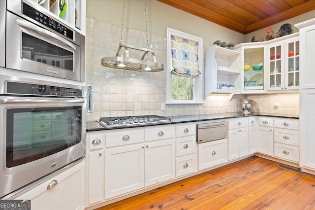 kitchen with tasteful backsplash, dark countertops, wooden ceiling, stainless steel gas stovetop, and a warming drawer
