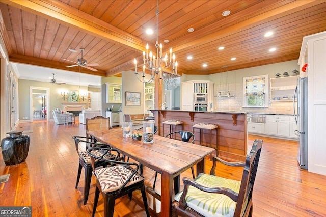 dining area featuring wood ceiling, crown molding, and light wood finished floors