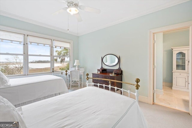 bedroom with ornamental molding, a ceiling fan, baseboards, and carpet floors