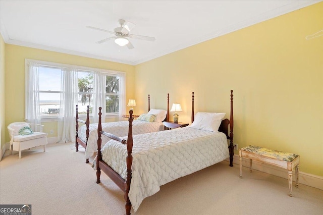 bedroom with light colored carpet, crown molding, baseboards, and ceiling fan