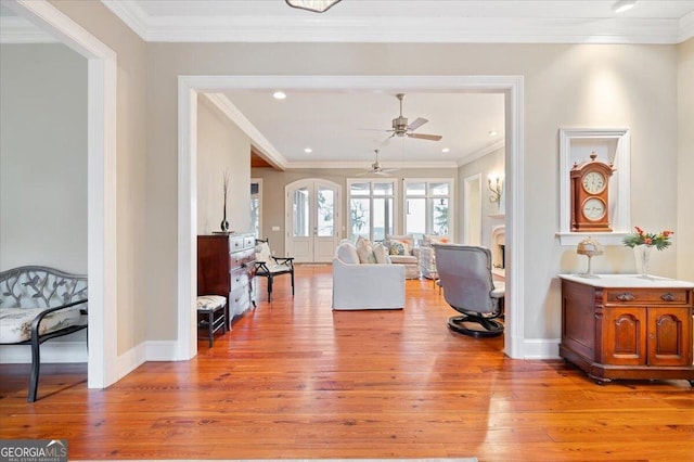 interior space with recessed lighting, light wood-style flooring, crown molding, and baseboards