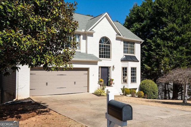 view of front of house with concrete driveway, a garage, brick siding, and a shingled roof