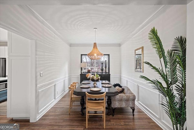 dining area with wainscoting, dark wood-style flooring, and ornamental molding