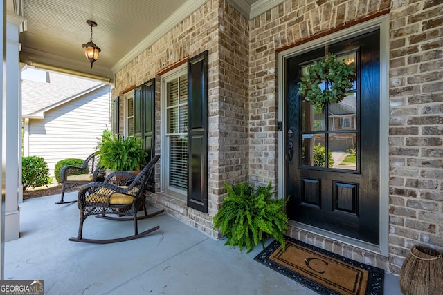 entrance to property featuring brick siding and a porch