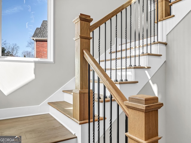 stairs featuring wood finished floors