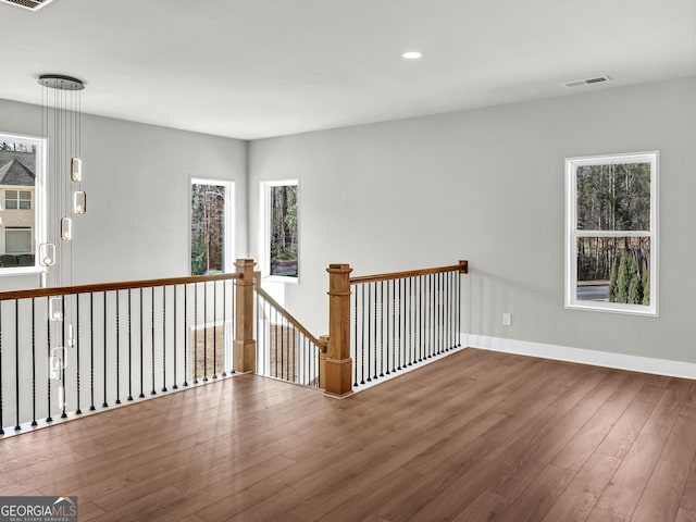 spare room with visible vents, recessed lighting, wood finished floors, and baseboards