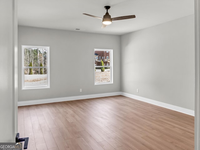 unfurnished room with visible vents, baseboards, light wood-style floors, and a ceiling fan