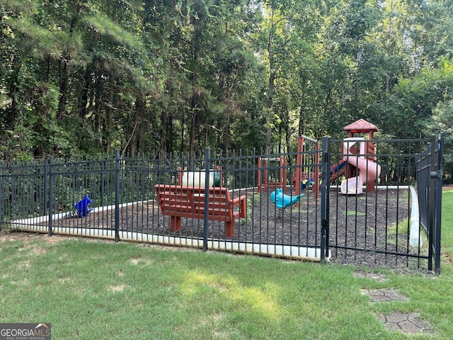 community jungle gym with a lawn and fence