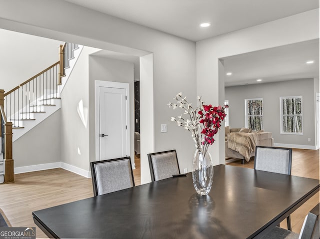 dining area with recessed lighting, baseboards, stairs, and light wood finished floors