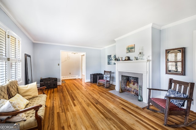 living area featuring a baseboard heating unit, crown molding, a fireplace with flush hearth, and wood finished floors