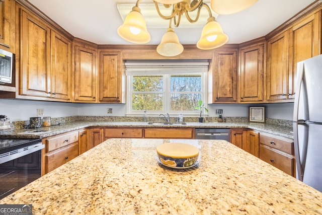 kitchen with a sink, brown cabinets, and appliances with stainless steel finishes