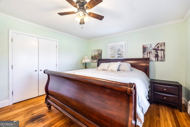 bedroom with ceiling fan, wood finished floors, a closet, and ornamental molding