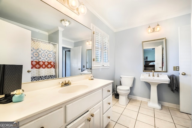 bathroom featuring crown molding, baseboards, toilet, tile patterned floors, and a sink