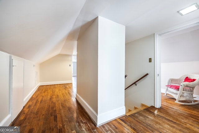 bonus room with baseboards, lofted ceiling, and hardwood / wood-style flooring