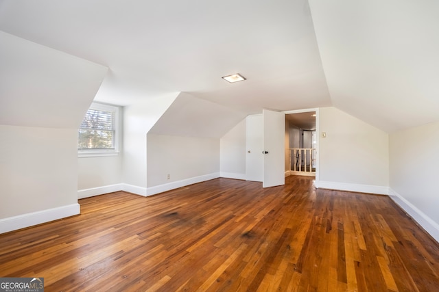 bonus room featuring hardwood / wood-style flooring, baseboards, and lofted ceiling