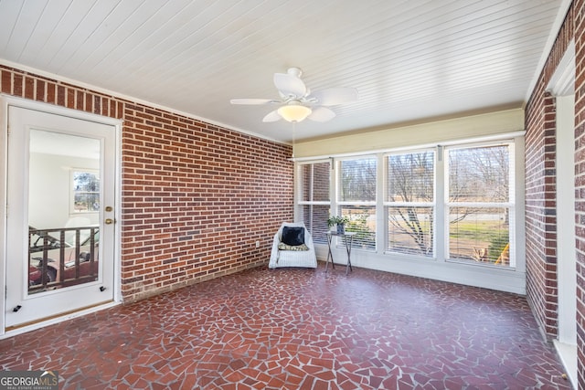 unfurnished sunroom featuring plenty of natural light and ceiling fan