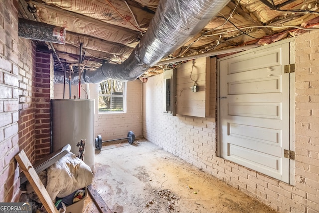 basement featuring gas water heater, electric panel, and brick wall