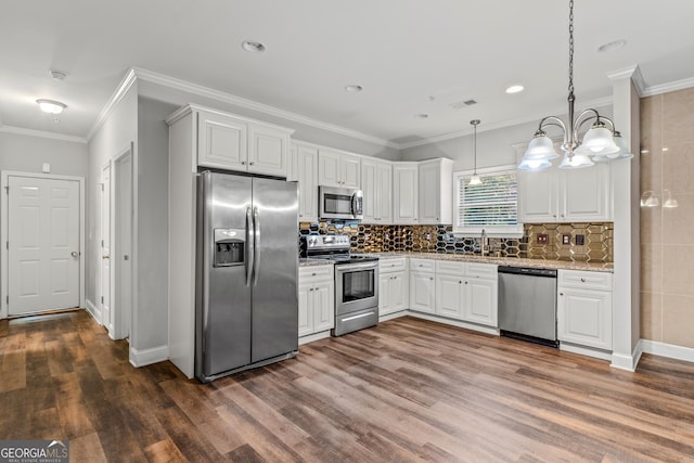 kitchen with decorative backsplash, crown molding, visible vents, and stainless steel appliances