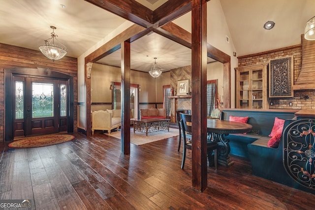 foyer featuring lofted ceiling, wood-type flooring, and a chandelier