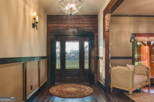 entryway featuring an inviting chandelier, hardwood / wood-style flooring, and wainscoting