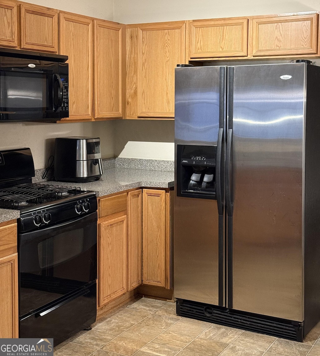 kitchen featuring black appliances and light countertops