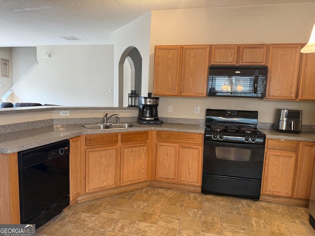 kitchen with visible vents, black appliances, arched walkways, a textured ceiling, and a sink