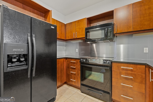 kitchen featuring black appliances, open shelves, dark countertops, brown cabinetry, and light tile patterned floors